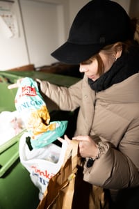 Woman recycling plastic.